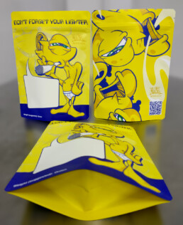 Three views of the yellow and blue John Kwes Breathe Easy one-ounce Mylar bag, showing its illustrated front, back and bottom gusset.